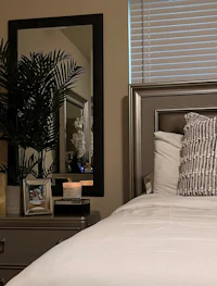 a bedroom with a bed and a mirror