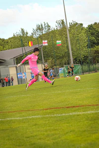 a soccer player kicking a soccer ball