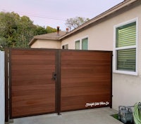 a wooden gate in front of a house