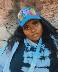 a black woman wearing a blue hat