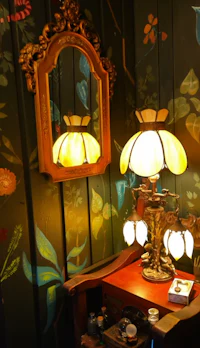 a lamp on a table next to a mirror