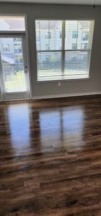 an empty living room with hardwood floors