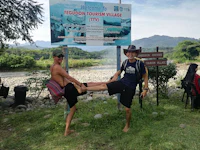 two men kicking in front of a sign
