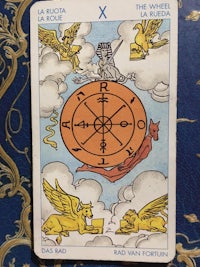 a tarot card with an image of an angel and a wheel