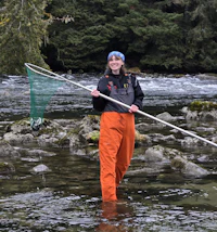 a woman holding a net in a river