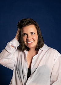 a woman in a white shirt is posing for a photo