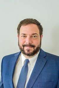 a man in a blue suit and tie