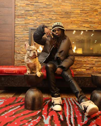a man sitting on a couch with a dog