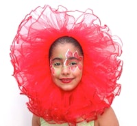 a young girl wearing a red tulle headdress