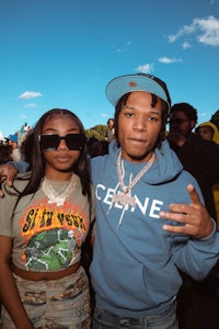 a man and woman standing next to each other at a festival