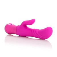 a pink sex toy lying on a white surface