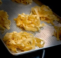fettuccine noodles on a baking sheet