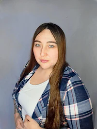 a woman in a plaid shirt posing for a photo