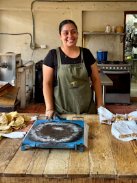 a woman standing in front of a table with food on it