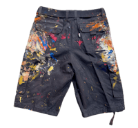a pair of men's shorts with paint splatters on them
