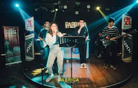 a group of people singing on stage at a nightclub