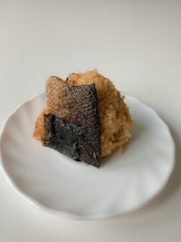 a plate with rice and a piece of fish on it