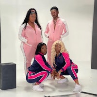 three women in pink tracksuits posing for a photo