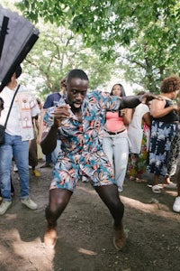 a man is dancing in front of a crowd of people