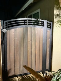 a wooden gate in a backyard at night