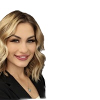 a woman in a black blazer posing for a photo