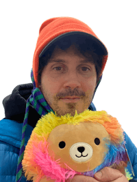 a man holding a colorful stuffed animal