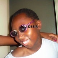 a young girl wearing sunglasses and a t shirt