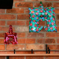 two balloons hanging from a brick wall