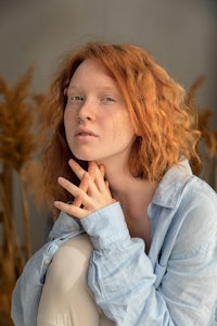a woman with red hair posing for a photo