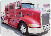 a red semi truck parked in a parking lot