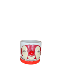 a clown mug with a red face on it