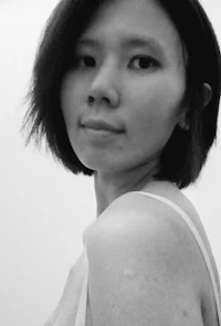 a black and white photo of a woman with short hair