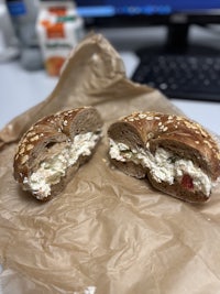 a bagel with a salad on top of it