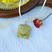 a necklace with a flower on it