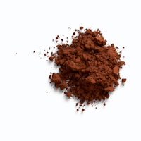 a pile of brown powder on a white background