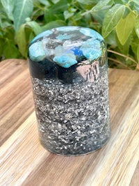 a glass jar filled with blue and silver stones