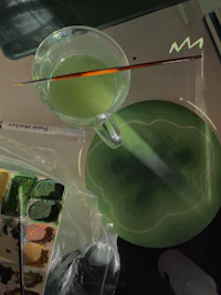 a cup of green liquid on a table
