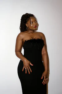 a woman in a black dress posing for a photo