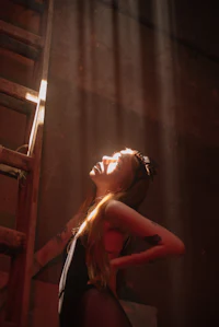 a woman leaning against a ladder