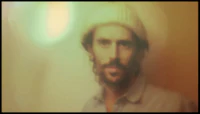 a blurry image of a man with a beard