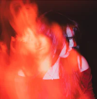 a blurry image of a woman with red hair