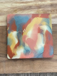 a piece of wood with a colorful painting on it