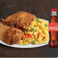 a plate of chicken and rice with a coca cola bottle
