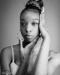 a black and white photo of a young woman posing