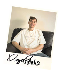 a man sitting on a couch with a t - shirt on