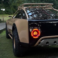 a tan car with a red tail light