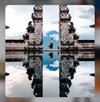 the reflection of a person standing in a pool