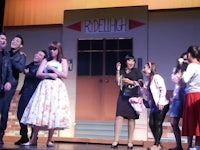 a group of people standing on stage on a stage