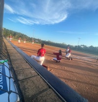 a group of softball players on the field