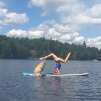 a woman standing on a paddle board in the water